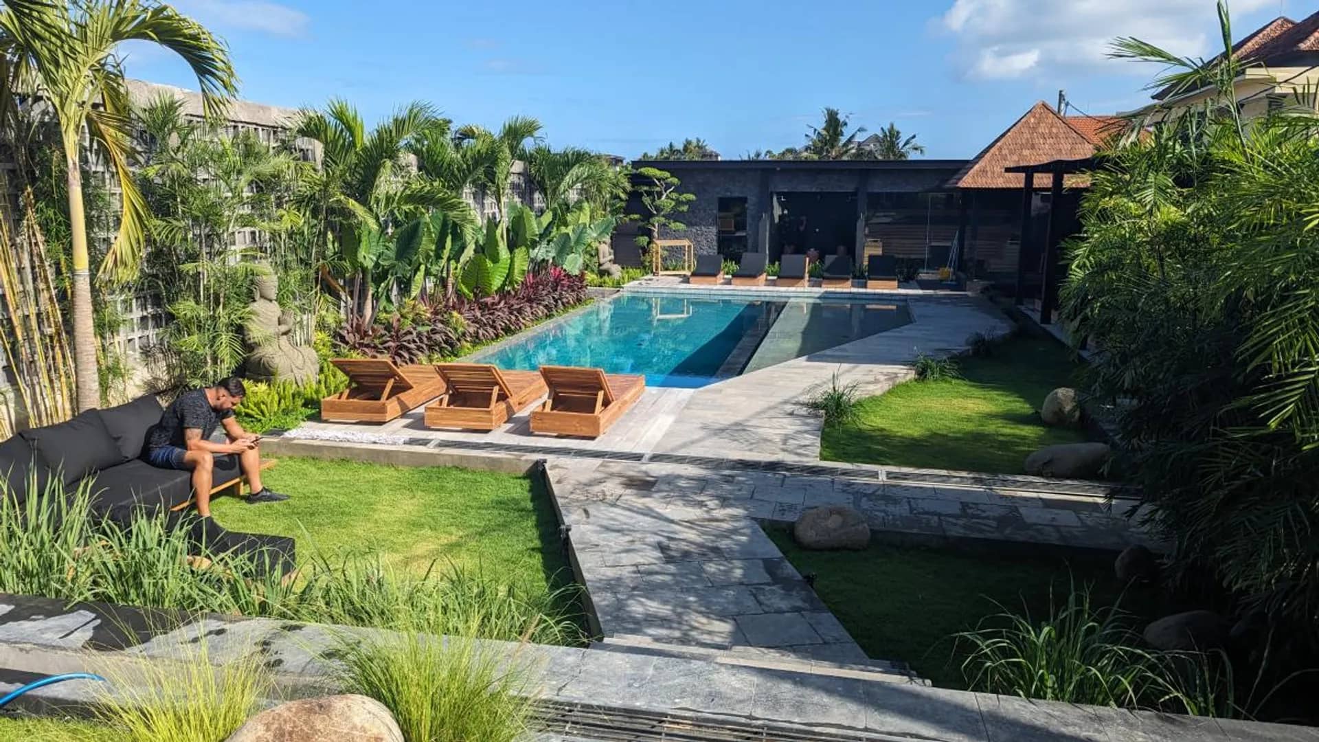 Sunlit villa living pavilion opening onto a private pool in Bali