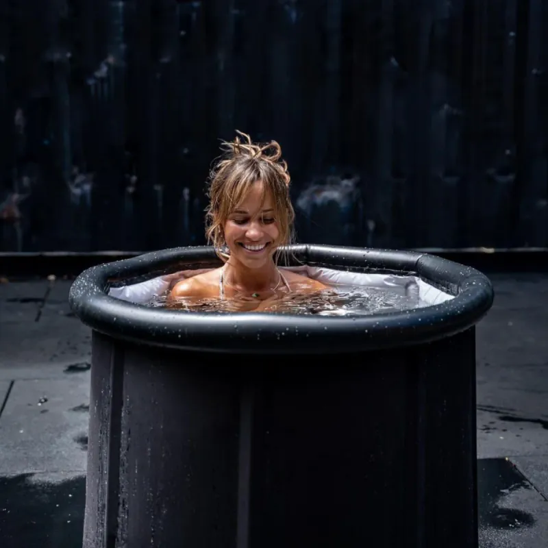 Woman in an ice bath cold plunge pool