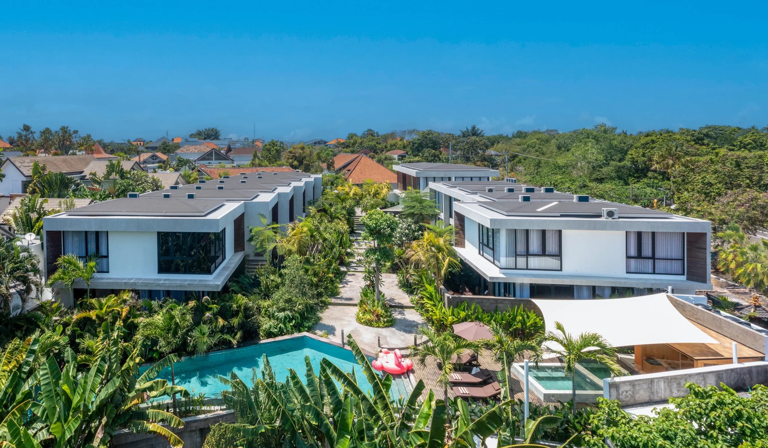 Aerial view of a private villa estate among rice fields in Umalas, Bali